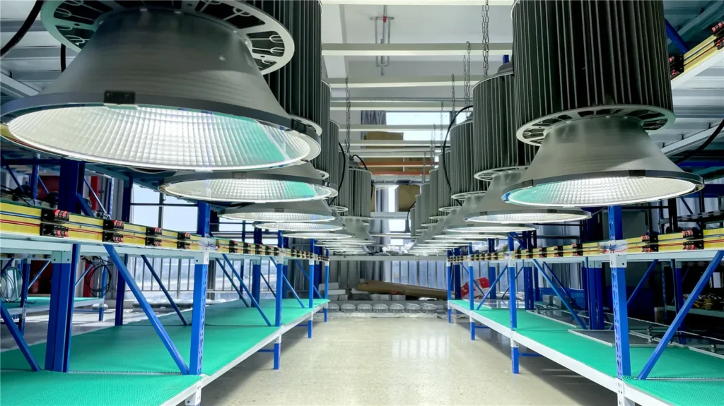 Rows of illuminated industrial LED luminaires undergoing aging testing at TORMIN.