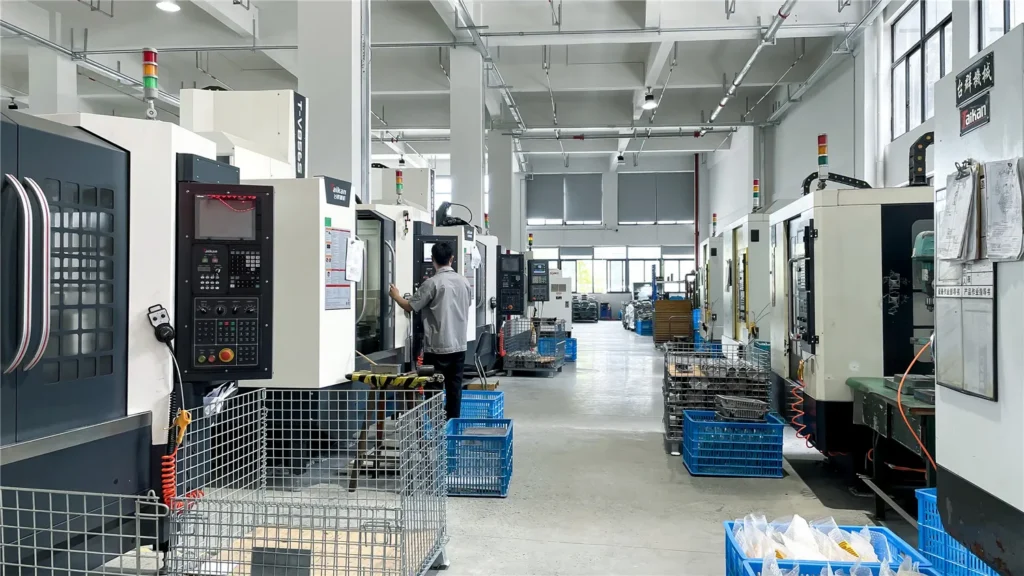 CNC machines and an operator in the TORMIN metalworking workshop.